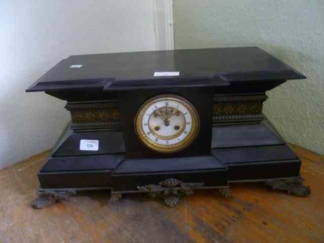 Appraisal: A VICTORIAN BLACK SLATE MANTEL CLOCK with cast brass supports