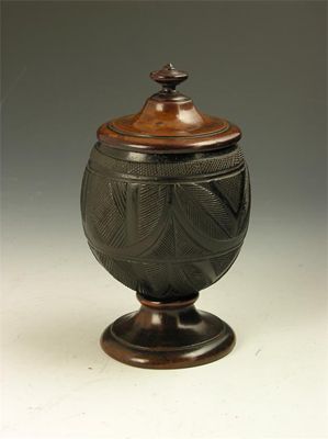 Appraisal: An early th century carved coconut bowl with a turned