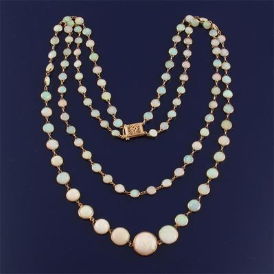 Appraisal: A two row graduated white opal necklace Gold 'spectacle' mounts