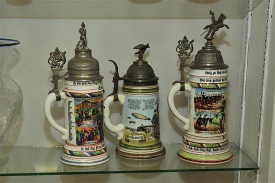 Appraisal: THREE LITHOPHANE STEINS German regimental steins with rampant lion eagle