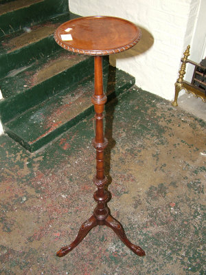 Appraisal: A mahogany torchere th century the carved circular top upon