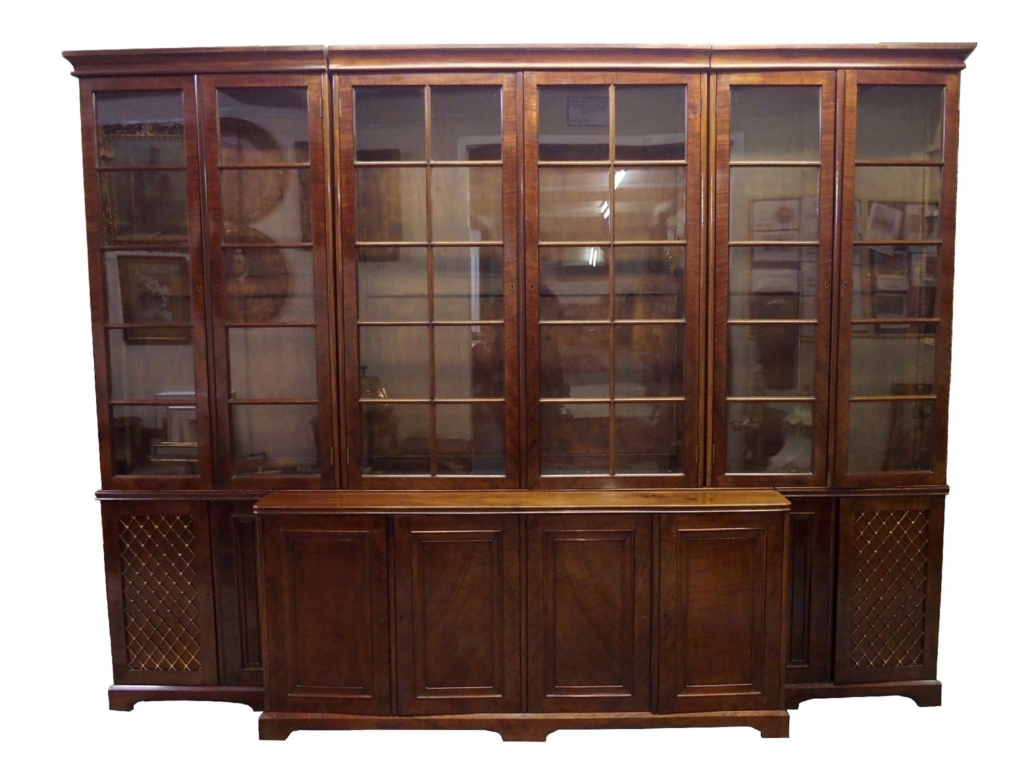 Appraisal: A mahogany breakfront library bookcasethe ogee cornice above six astragal