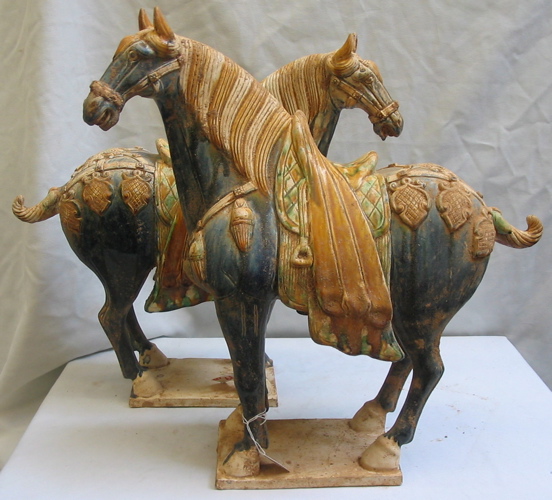 Appraisal: PAIR TANG STYLE POTTERY HORSES traditional blue and black glaze