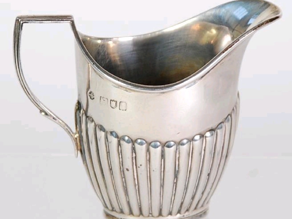 Appraisal: GEORGIAN STYLE HELMET SHAPED SILVER CREAM JUG oval and semi