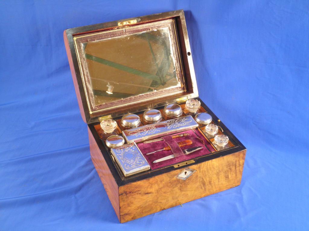 Appraisal: A Victorian walnut dressing case the domed top inlaid in