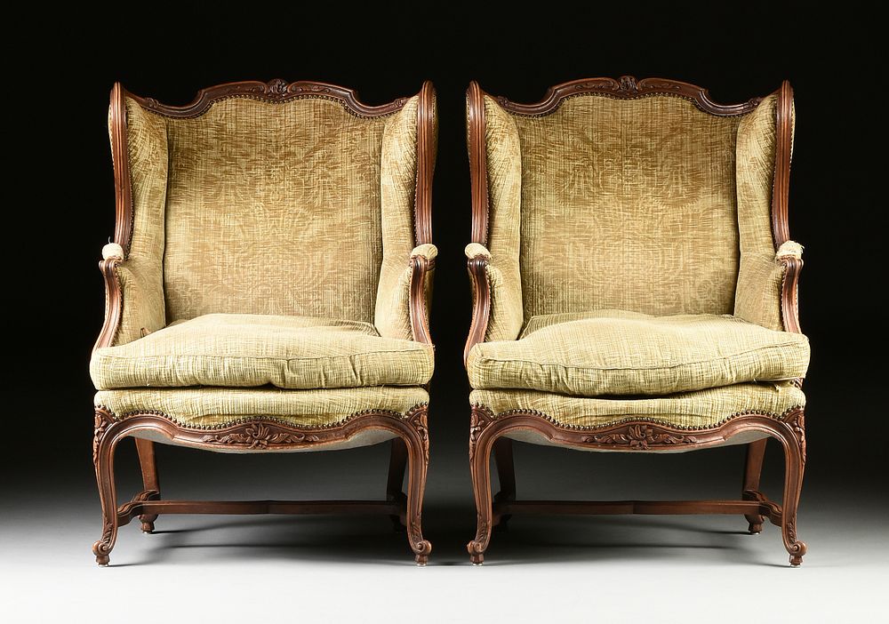 Appraisal: A PAIR OF LOUIS XV STYLE UPHOLSTERED AND CARVED WALNUT