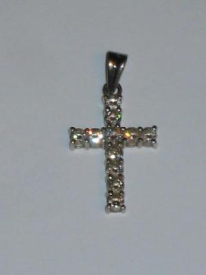 Appraisal: A DIAMOND CROSS claw set with eleven brilliant cut diamonds