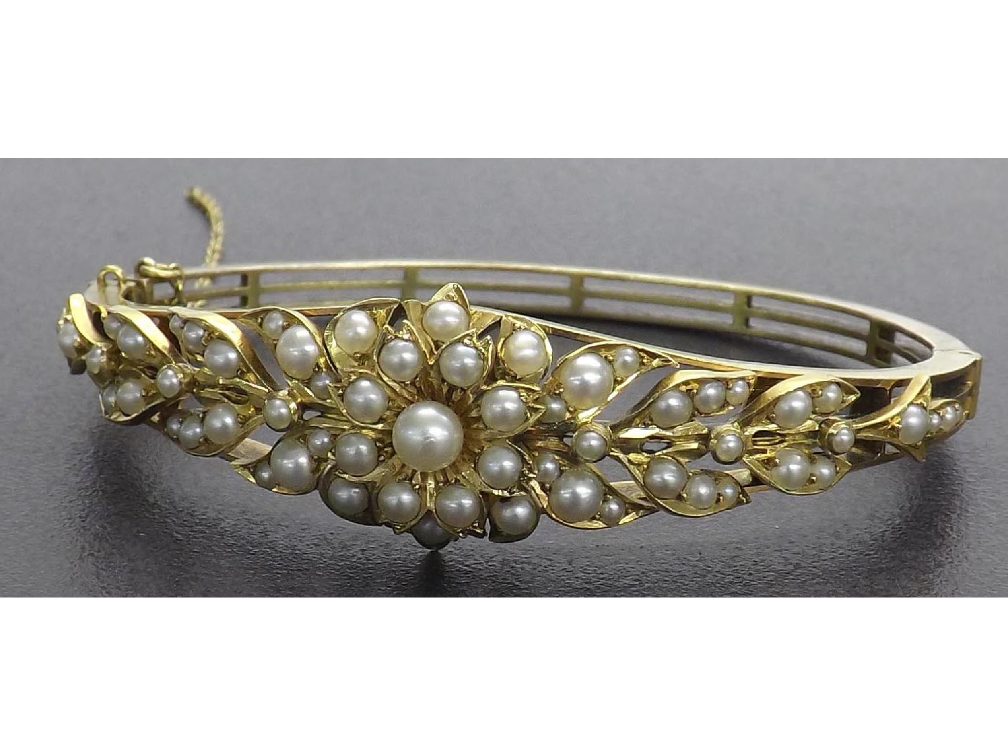 Appraisal: Victorian gold pearl set floral design bangle unmarked gm