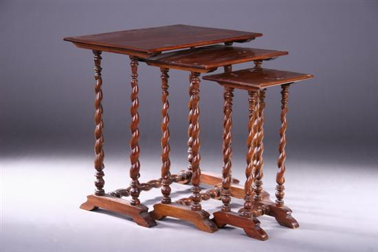 Appraisal: THREE AMERICAN WALNUT NESTING TABLES Mid- th century Each rectangular