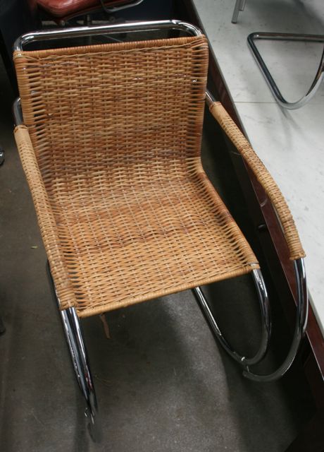 Appraisal: A pair of chrome and caned tubular framed armchairs