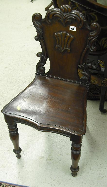 Appraisal: Victorian mahogany hall chair the shield back within a foliate