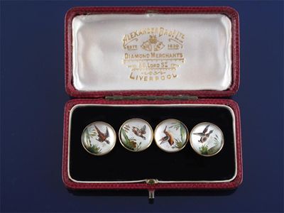 Appraisal: A pair of reverse carved crystal game bird cufflinks painted