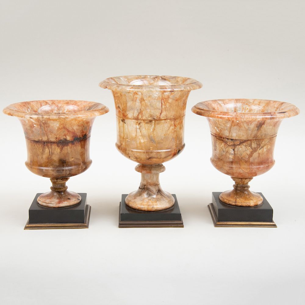 Appraisal: Derbyshire Fluorspar Three-Piece Campagna Garniture Each on bronze-mounted black marble