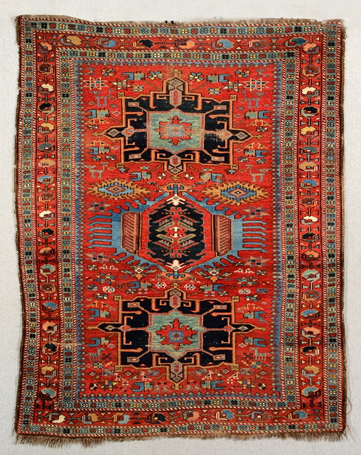 Appraisal: A KARAJAH RUST GROUND RUG decorated a central triple medallion