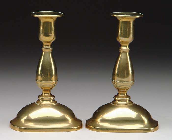 Appraisal: PAIR OF BRASS PEG LAMPS Peg lamp fonts in milk