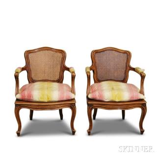 Appraisal: Pair of Louis XV-style Caned Walnut Fauteuils each with carved