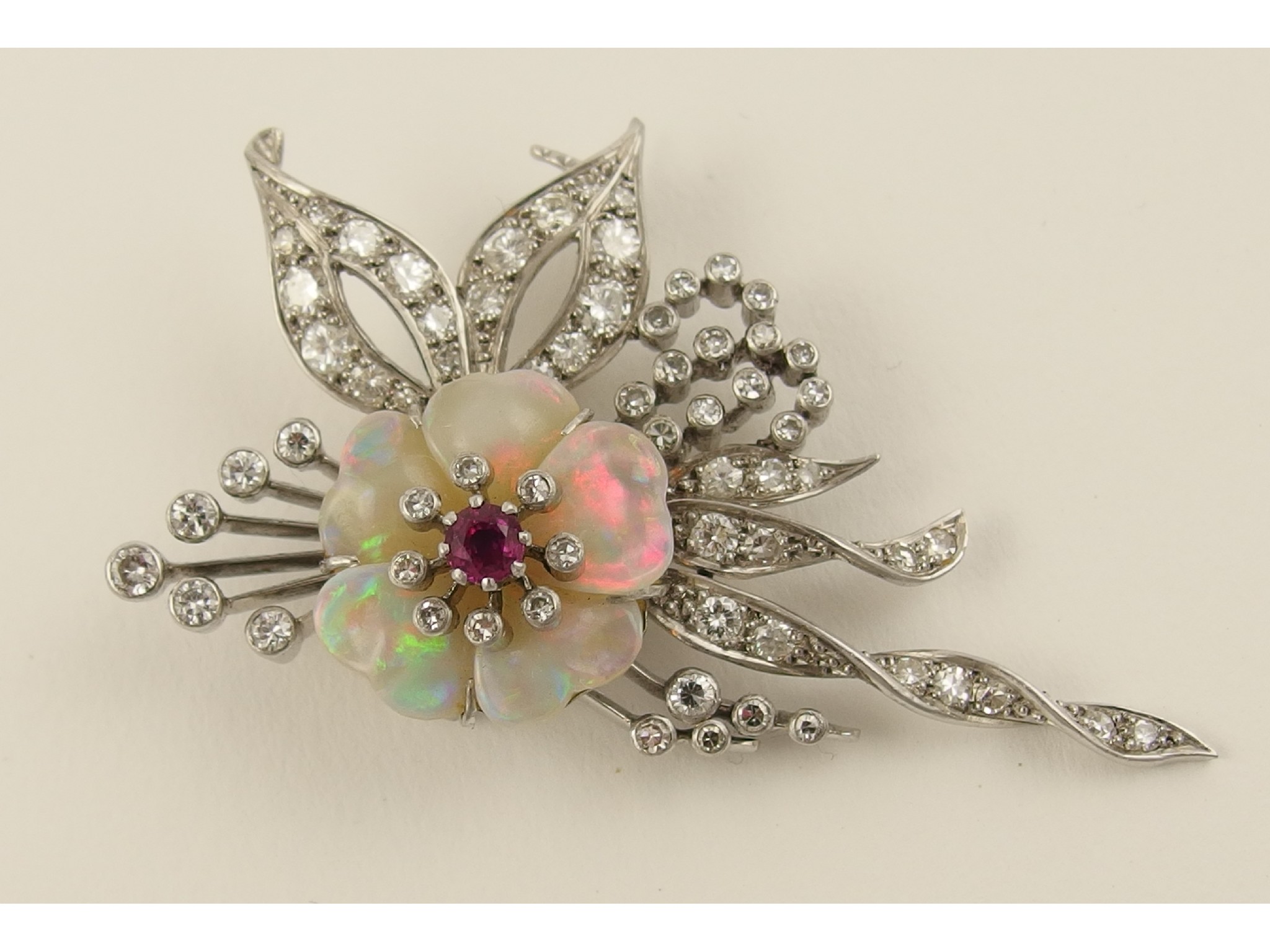 Appraisal: A diamond and opal flower broochin platinum and ct white