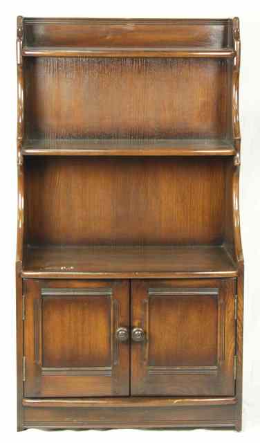 Appraisal: An oak dwarf bookcase with two-door cupboard under cm wide