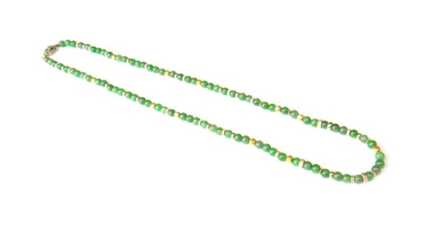 Appraisal: A single row necklace of spherical jade beads with decorated