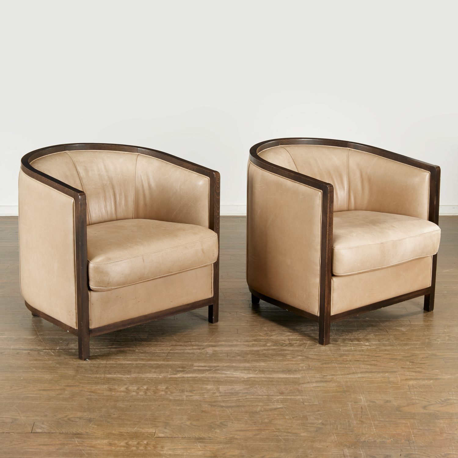 Appraisal: PAIR DONGHIA LEATHER UPHOLSTERED BARREL CHAIRS th st c beige