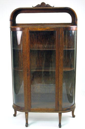 Appraisal: AN OAK AND CURVED GLASS CHINA DISPLAY CABINET American c