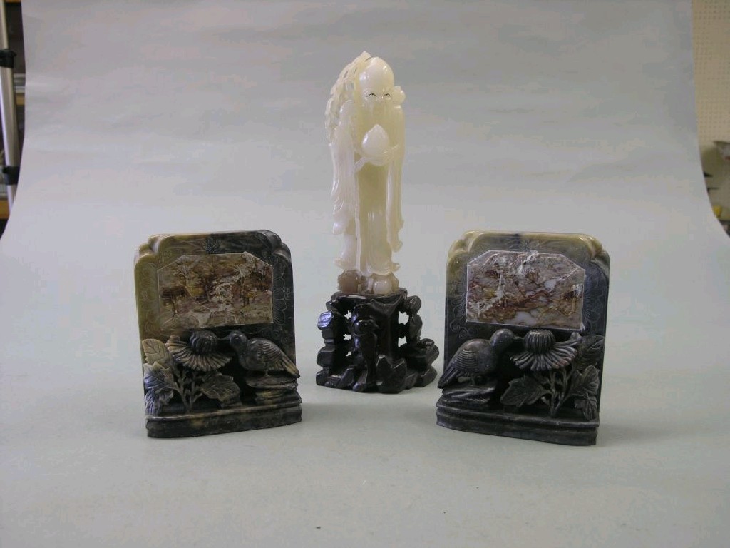 Appraisal: A pair of carved soapstone figures a pair of carved