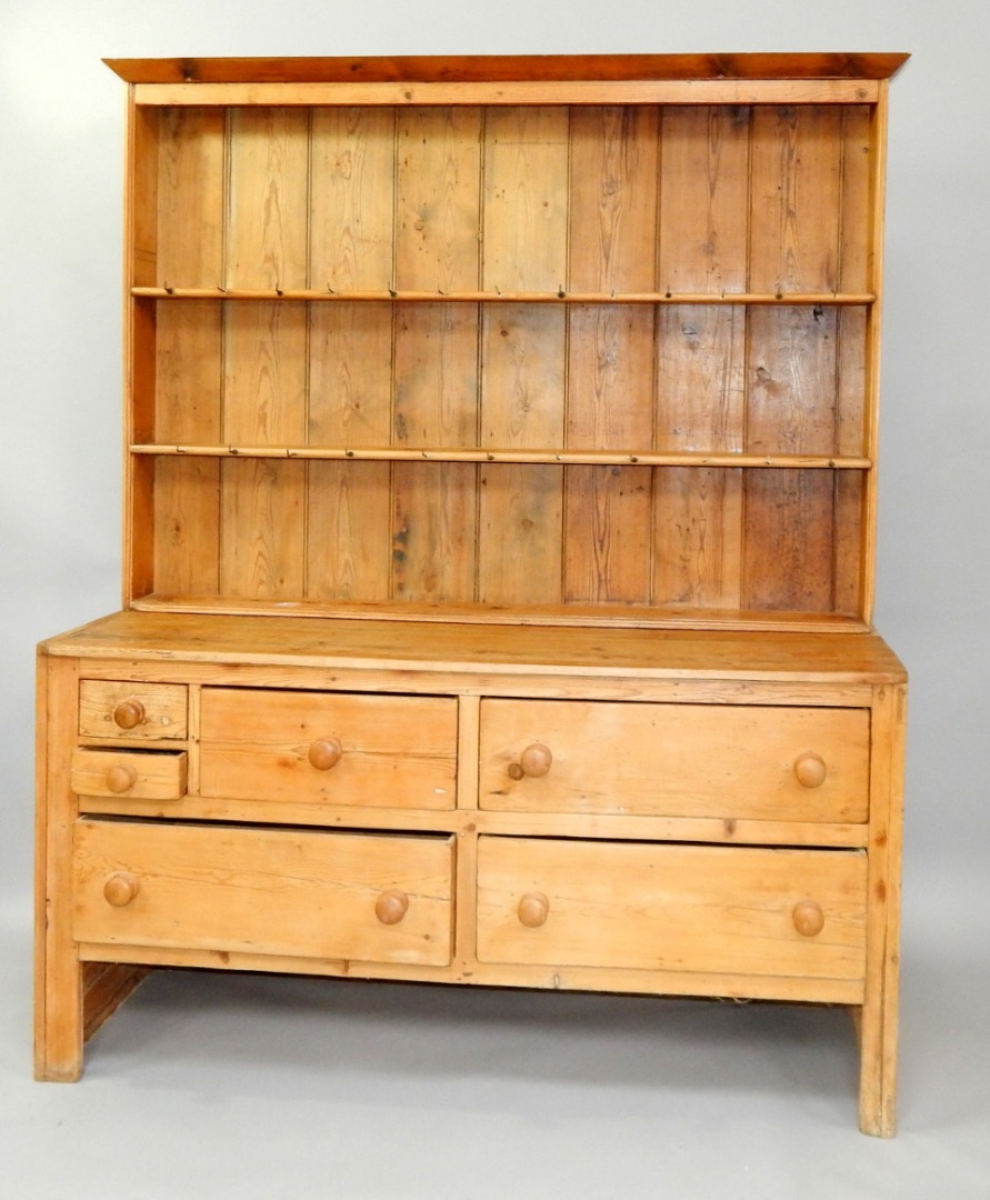 Appraisal: A pine dresser with two shelf Delft rack over two