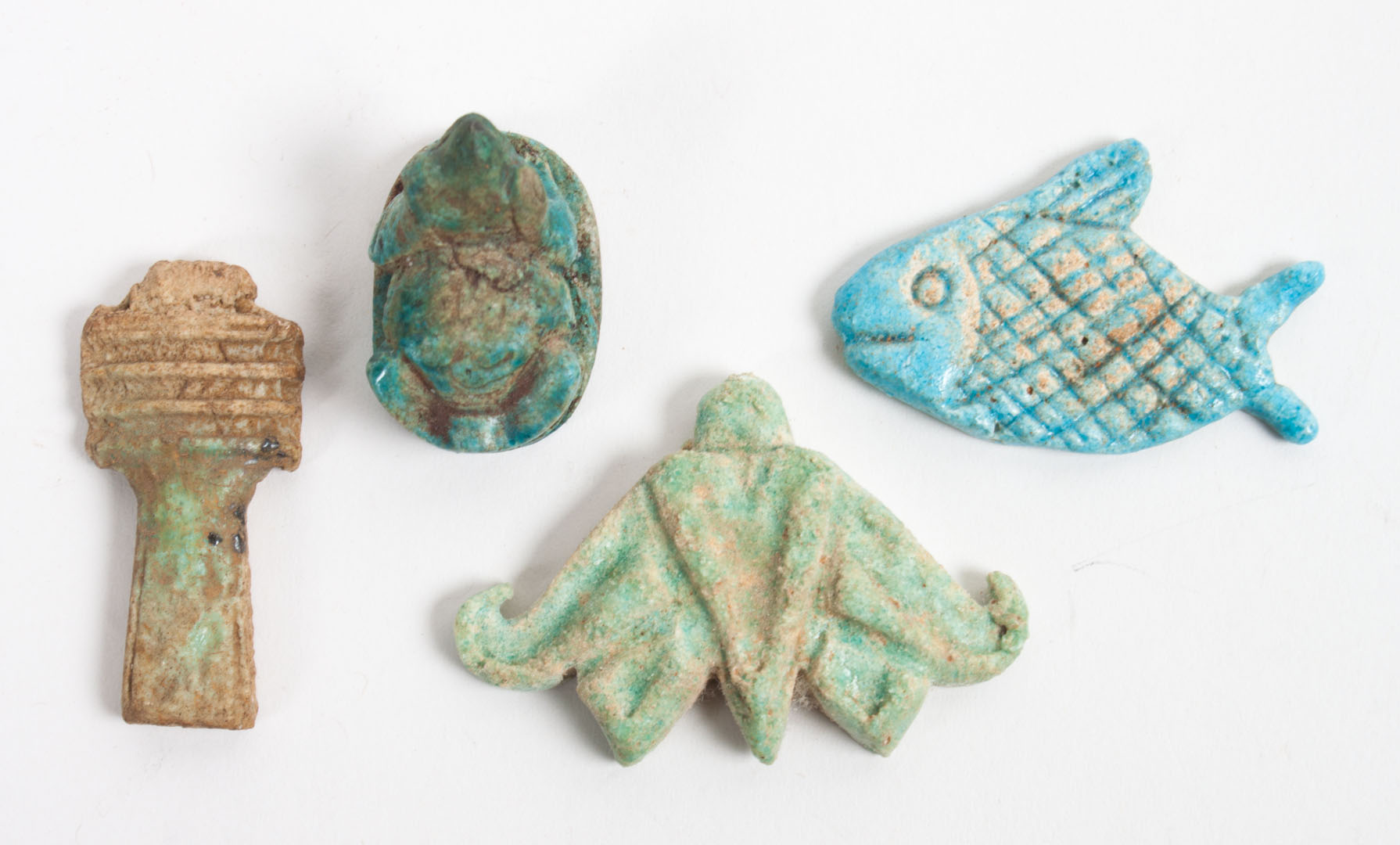 Appraisal: Four ancient Egyptian faience amulets comprising frog on a base