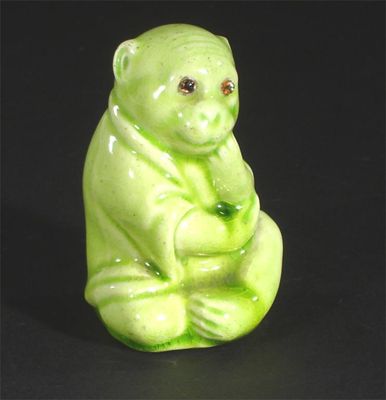 Appraisal: A rare Burmantoft's Faience monkey with applied glass eyes glazed