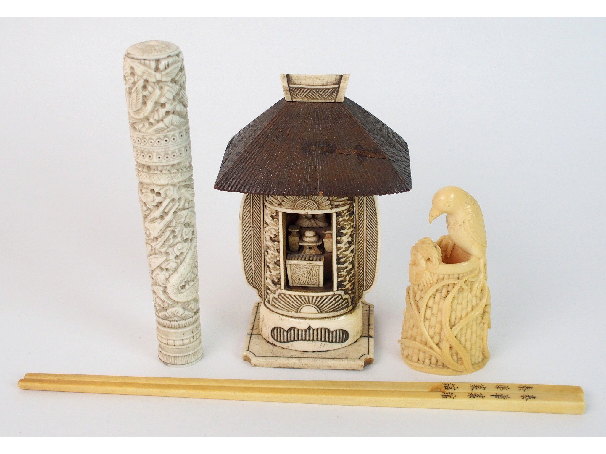 Appraisal: A Japanese carved ivory model of a birdperched on a