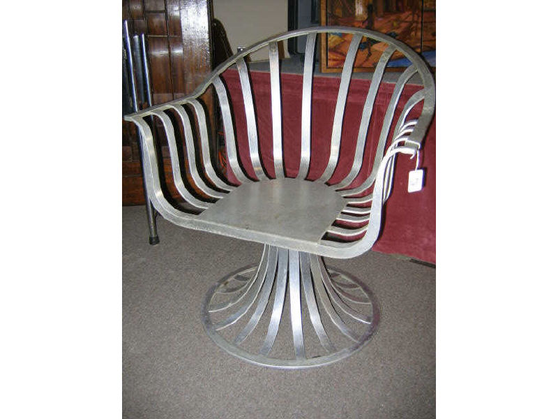 Appraisal: AMERICAN SCHOOL Aluminum armchair slat work shell raised on a