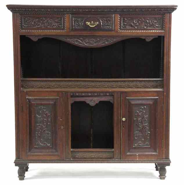 Appraisal: A carved walnut cabinet fitted a drawer central recess and