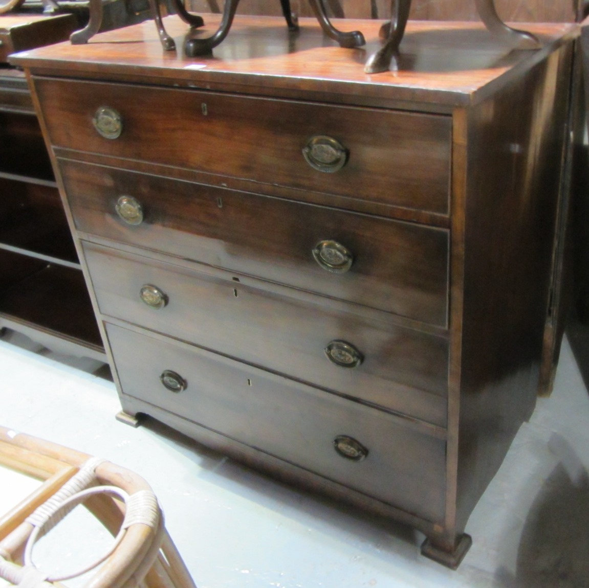 Appraisal: A George III mahogany chest of four long graduated drawers