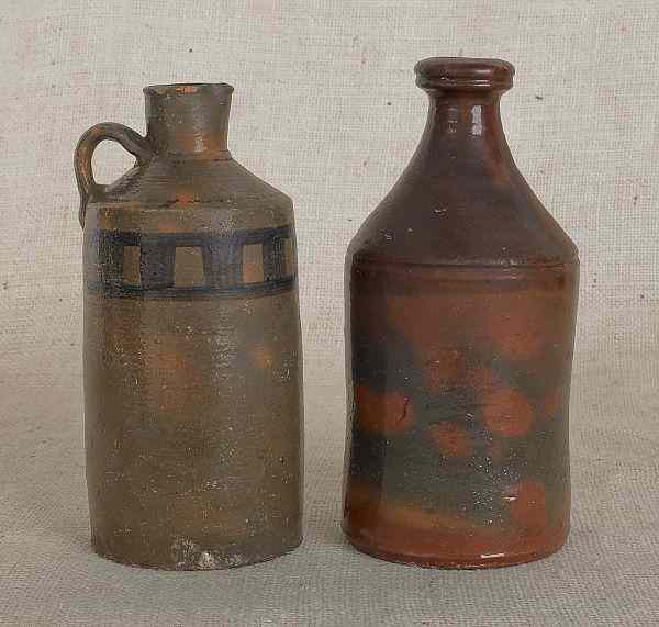 Appraisal: Two American redware bottles th c with green and orange