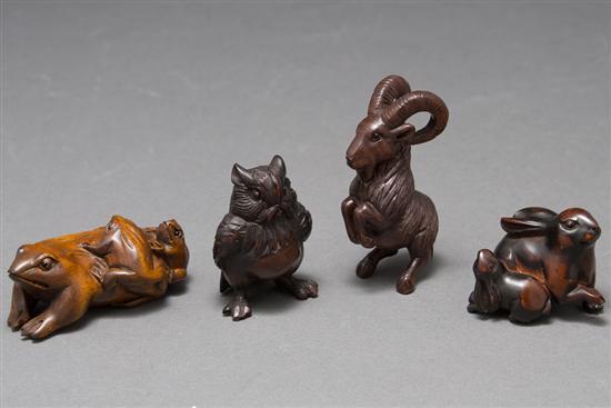 Appraisal: Four Japanese carved wood netsukes frog with two young on