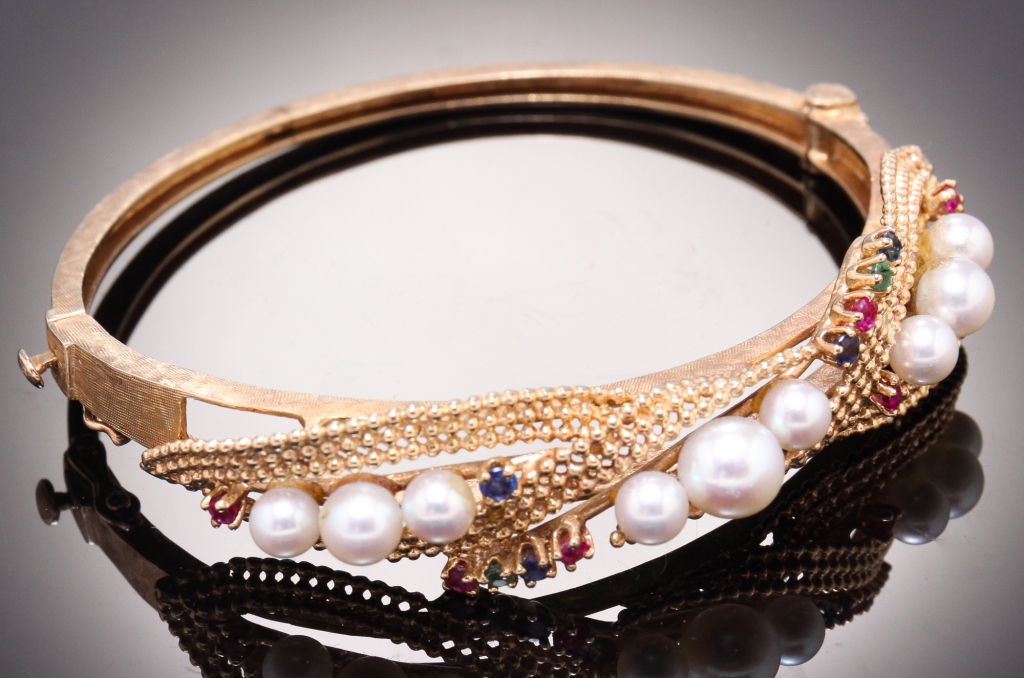 Appraisal: KARAT PEARL AND GEMSTONE BANGLE BRACELET American nd half th