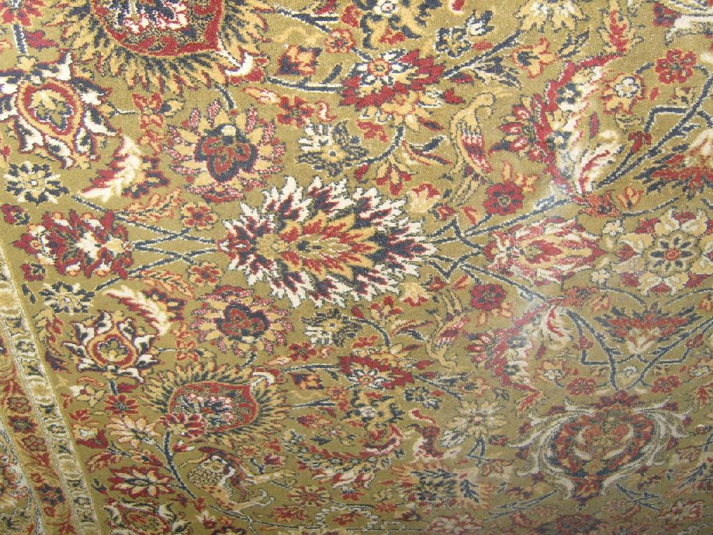 Appraisal: A large green ground wool carpet with all over stylised