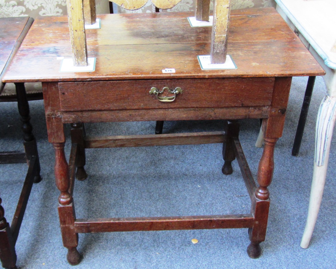 Appraisal: An early th century oak single drawer side table on