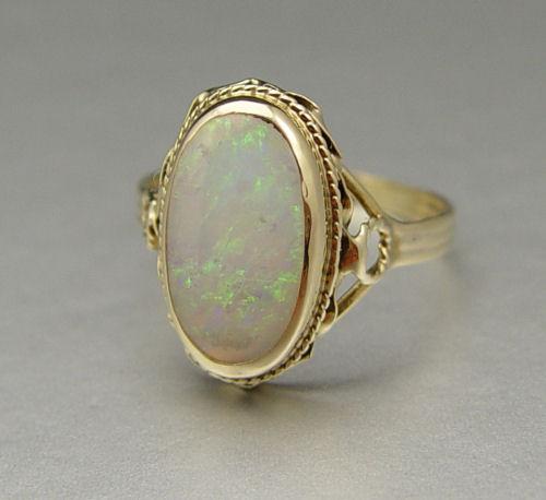 Appraisal: K SEMI-CRYSTAL OPAL RING K yellow gold ring contains one