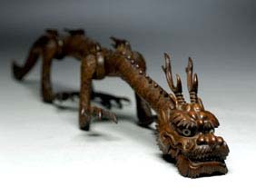 Appraisal: ANTIQUE ARTICULATED WOOD DRAGON Antique Japanese Meiji Period meticulously carved