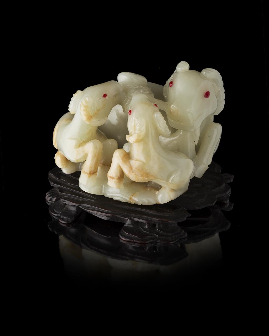 Appraisal: WHITE JADE CARVED RAM GROUP well carved in the form