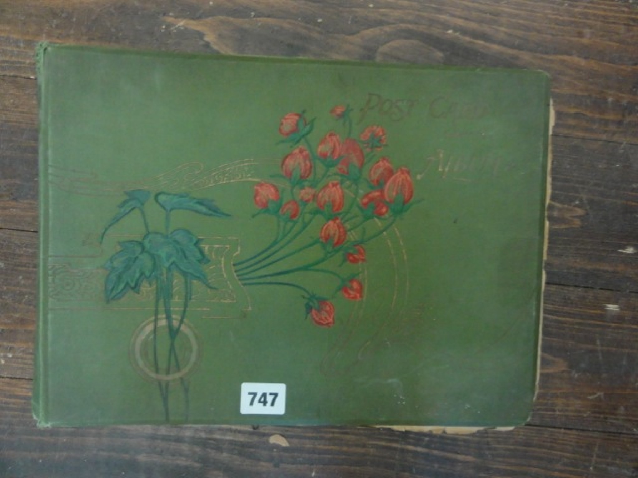 Appraisal: An Edwardian postcard album containing a miscellaneous selection of card