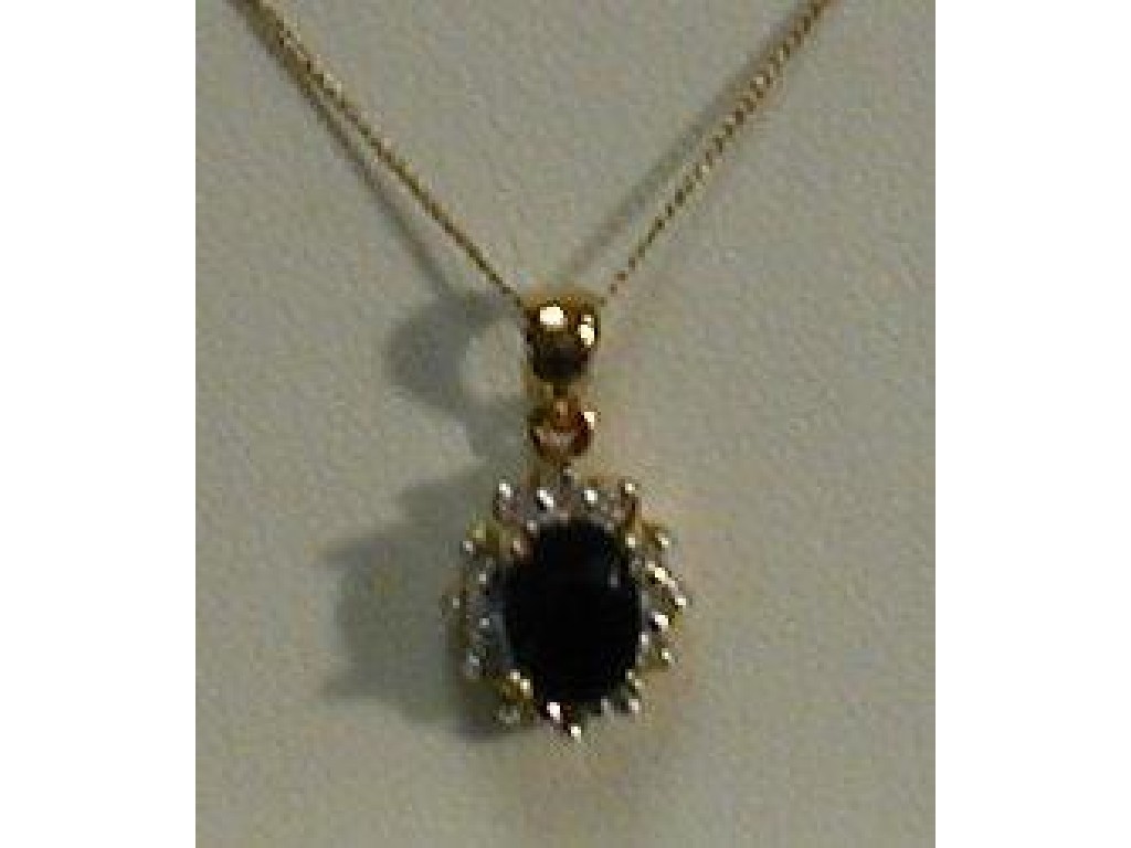 Appraisal: A diamond and sapphire pendant the oval sapphire mm x