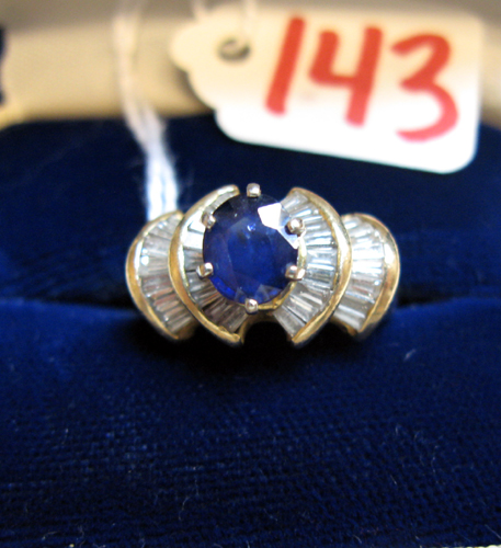 Appraisal: SAPPHIRE DIAMOND AND FOURTEEN KARAT GOLD RING centering an oval-cut