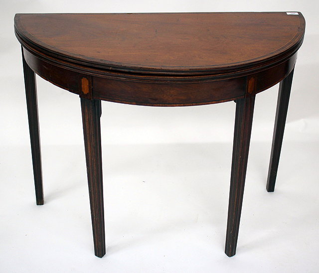 Appraisal: A TH CENTURY MAHOGANY DEMI-LUNE FOLDOVER TEA TABLE with four