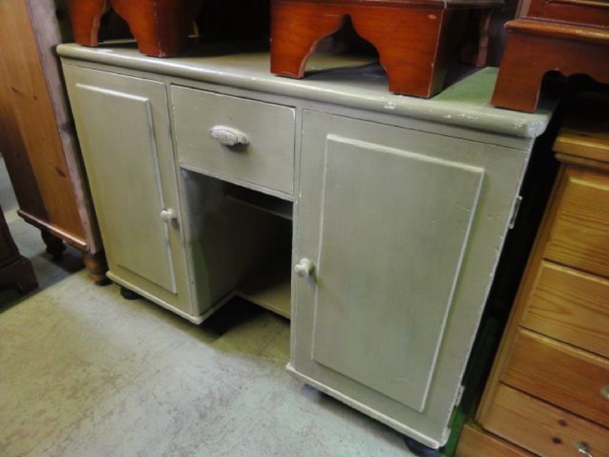 Appraisal: A Victorian pine side cupboard dresser base enclosed by a