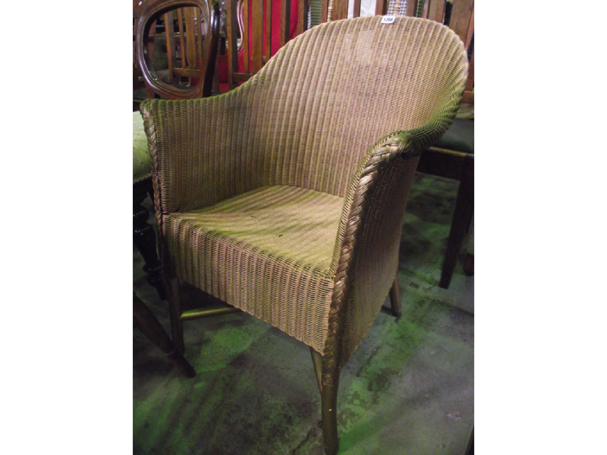 Appraisal: A Lloyd Loom armchair with gilt painted finish