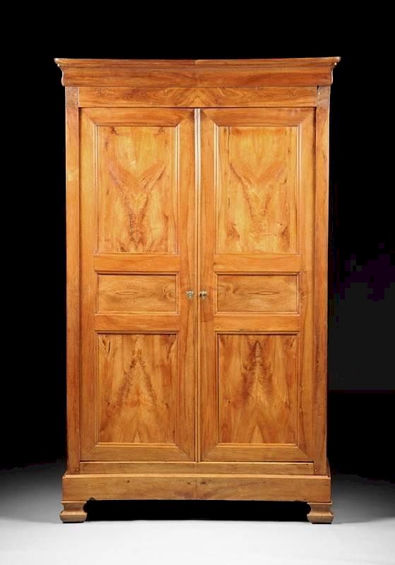 Appraisal: A FRENCH PROVINCIAL CARVED CHERRY ARMOIRE EARLY TH CENTURY A