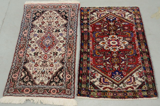 Appraisal: - Two similar Persian oriental mats with red fields and