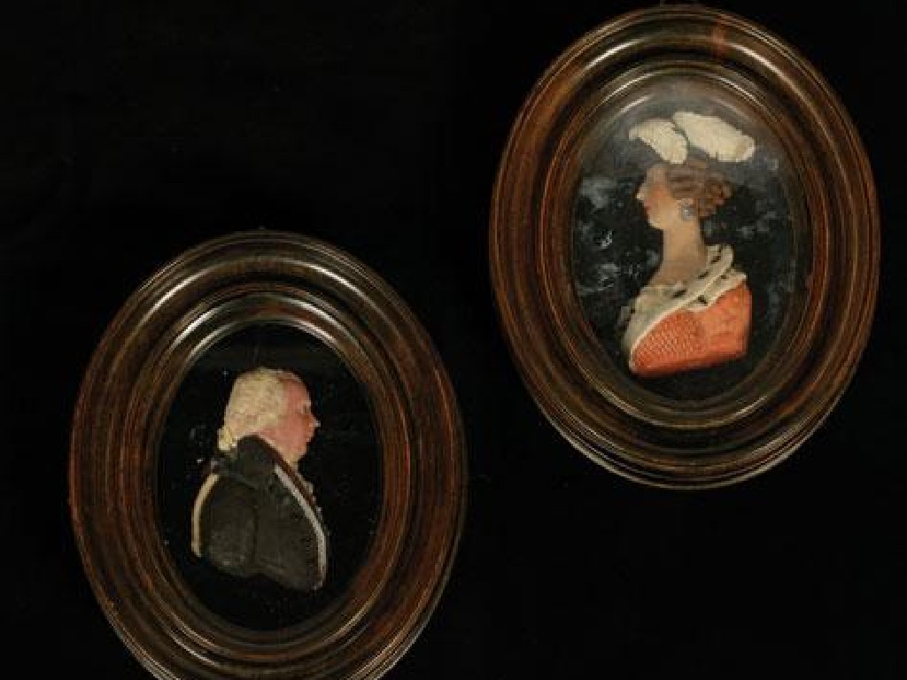 Appraisal: A PAIR OF GEORGE III PAINTED WAX PORTRAIT MINIATURES of